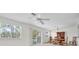 A well lit dining room is shown with neutral walls, ceiling fan, a dining table and a scenic view at 8181 Eagles Park N Dr, St Petersburg, FL 33709
