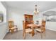 Traditional dining room with a wooden table, chairs, hutch, and soft natural light at 8181 Eagles Park N Dr, St Petersburg, FL 33709