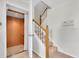 Interior residential elevator with wood paneling next to stairs with wood railing at 8181 Eagles Park N Dr, St Petersburg, FL 33709