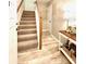 Inviting entryway features wood-look tile flooring and a staircase leading to the upper level at 8181 Eagles Park N Dr, St Petersburg, FL 33709
