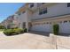 Townhome featuring an attached garage, well-maintained landscaping, and a welcoming entrance at 8181 Eagles Park N Dr, St Petersburg, FL 33709