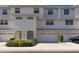 Charming townhome with a two-car garage, neutral exterior, and landscaped front yard at 8181 Eagles Park N Dr, St Petersburg, FL 33709