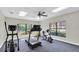 Fitness room equipped with treadmill, elliptical machine, and stationary bike by bright windows at 8181 Eagles Park N Dr, St Petersburg, FL 33709