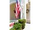 Inviting front entrance with an American flag, decorative wreath, and 'For Sale' sign at 8181 Eagles Park N Dr, St Petersburg, FL 33709