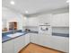 Open concept kitchen has white cabinets, lots of counter space and is open to the dining area at 8181 Eagles Park N Dr, St Petersburg, FL 33709