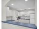 Open concept kitchen featuring white cabinets, white subway tile, and dark countertops at 8181 Eagles Park N Dr, St Petersburg, FL 33709