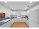 Open concept kitchen with white cabinets and dark countertops features wood flooring at 8181 Eagles Park N Dr, St Petersburg, FL 33709