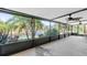 Spacious screened-in lanai with picturesque views of the lake, greenery, and landscaping at 8181 Eagles Park N Dr, St Petersburg, FL 33709