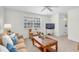 Relaxing living room with soft carpet, neutral walls, and a classic wood-trimmed coffee table at 8181 Eagles Park N Dr, St Petersburg, FL 33709