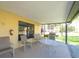 Outdoor patio with seating and a grill, perfect for relaxing and entertaining with views of manicured lawn at 8181 Eagles Park N Dr, St Petersburg, FL 33709