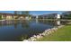 Scenic view of a tranquil pond with a fountain, surrounded by lush landscaping and nearby buildings at 8181 Eagles Park N Dr, St Petersburg, FL 33709