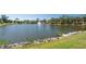 Picturesque pond featuring a fountain, set against a backdrop of lush greenery and community buildings at 8181 Eagles Park N Dr, St Petersburg, FL 33709