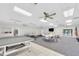 Spacious recreation room featuring a ping pong table, seating, and natural light at 8181 Eagles Park N Dr, St Petersburg, FL 33709