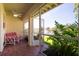 Cozy, screened patio with seating and vibrant plants offering serene lake views and lush foliage at 8181 Eagles Park N Dr, St Petersburg, FL 33709