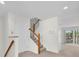 Well-lit staircase with carpeted steps and white banisters leading to the upper level at 8181 Eagles Park N Dr, St Petersburg, FL 33709