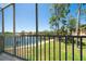 Balcony view featuring a tranquil lake with a fountain, lush greenery, and a paved walkway at 8181 Eagles Park N Dr, St Petersburg, FL 33709