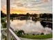 Scenic lake view with fountain, surrounded by lush landscaping and trees, captured at sunset with a vibrant, colorful sky at 8181 Eagles Park N Dr, St Petersburg, FL 33709