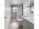 This bathroom features a glass-enclosed shower, marbled tile, and updated fixtures at 8451 81St Way, Seminole, FL 33777