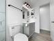 This bathroom features a light gray vanity with updated fixtures, mirror, and updated toilet at 8451 81St Way, Seminole, FL 33777