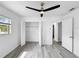 Bedroom featuring updated floors, a ceiling fan, closet space, and natural lighting at 8451 81St Way, Seminole, FL 33777