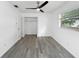 This bedroom features modern flooring, a ceiling fan, ample closet space, and natural lighting at 8451 81St Way, Seminole, FL 33777
