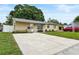Charming single-story home featuring a well-manicured lawn, mature trees and a long driveway at 8451 81St Way, Seminole, FL 33777