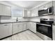 Modern kitchen boasts stainless steel appliances, a window view and updated cabinetry at 8451 81St Way, Seminole, FL 33777