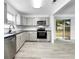 Modern kitchen with stainless steel appliances and gray cabinets at 8451 81St Way, Seminole, FL 33777
