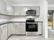 Updated kitchen features stainless steel appliances, sleek countertops and abundant cabinetry at 8451 81St Way, Seminole, FL 33777
