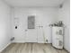Bright laundry room with modern flooring, water heater and door to the exterior at 8451 81St Way, Seminole, FL 33777