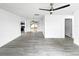 Large living room with modern flooring, flowing into the kitchen and back patio at 8451 81St Way, Seminole, FL 33777