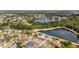 Aerial view of a residential area with a lake and tree coverage at 8638 Chadwick Dr, Tampa, FL 33635