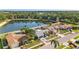 A stunning aerial view reveals a beautiful lakefront property with lush green surroundings and well-maintained homes in the neighborhood at 8638 Chadwick Dr, Tampa, FL 33635
