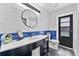 Elegant bathroom boasts modern fixtures, a shiplap wall, and stylish vanity at 8638 Chadwick Dr, Tampa, FL 33635