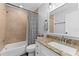 Cozy bathroom featuring granite counters, tan tile in the shower, and updated fixtures at 8638 Chadwick Dr, Tampa, FL 33635