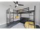 Bedroom with black bunk beds, yellow accents, a modern ceiling fan, and natural light at 8638 Chadwick Dr, Tampa, FL 33635