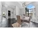 Bright dining room featuring a large window, modern lighting, and a stylish round table with comfortable seating at 8638 Chadwick Dr, Tampa, FL 33635