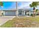 A beautiful single-story house with a two-car garage and palm trees at 8638 Chadwick Dr, Tampa, FL 33635