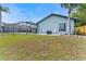 A tranquil outdoor area features a lovely seating spot on a patio with a backyard, a lake view, and a beautiful blue house at 8638 Chadwick Dr, Tampa, FL 33635