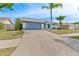 Single-story home with a two-car garage and well-maintained lawn at 8638 Chadwick Dr, Tampa, FL 33635