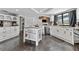 Spacious kitchen with white cabinetry, granite countertops, a center island, and modern stainless steel appliances at 8638 Chadwick Dr, Tampa, FL 33635