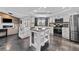 Bright kitchen featuring a center island, stainless steel appliances, and an open layout leading to the living area at 8638 Chadwick Dr, Tampa, FL 33635