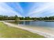 Scenic lake view with a sandy beach and lush green surroundings, offering a serene and picturesque natural landscape at 8638 Chadwick Dr, Tampa, FL 33635