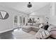 Bright living room with a comfortable gray sectional sofa and open access to the kitchen and outdoor patio at 8638 Chadwick Dr, Tampa, FL 33635