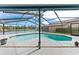 Beautiful screened-in pool area offers a relaxing outdoor oasis with a lake view at 8638 Chadwick Dr, Tampa, FL 33635