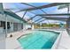 A beautiful in-ground pool with a screened-in enclosure offers stunning waterfront views, creating a serene backyard oasis at 8638 Chadwick Dr, Tampa, FL 33635