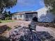 Spacious backyard with a fire pit, patio, and lawn at 910 Robinson N Dr, St Petersburg, FL 33710