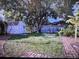 Large backyard with shed, mature trees, grass, and brick path at 910 Robinson N Dr, St Petersburg, FL 33710