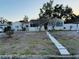 Charming single-story home featuring a well-manicured lawn and inviting walkway at 910 Robinson N Dr, St Petersburg, FL 33710