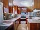 The kitchen features custom cabinets, granite counters, and stainless appliances at 910 Robinson N Dr, St Petersburg, FL 33710